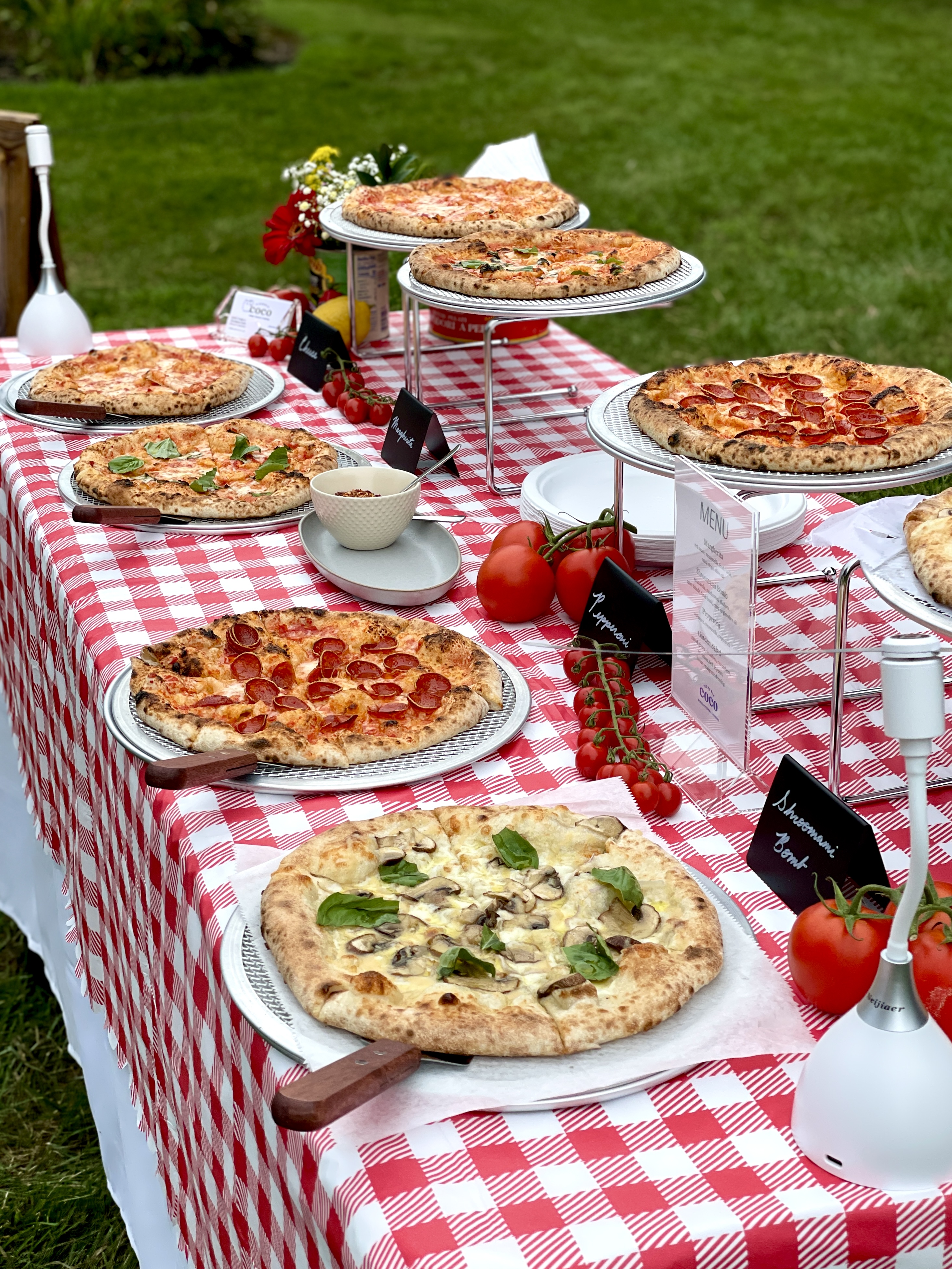 Mobile brick-oven pizza buffet catering setup at an outdoor event in Montgomery County, Maryland, serving the greater DMV area.