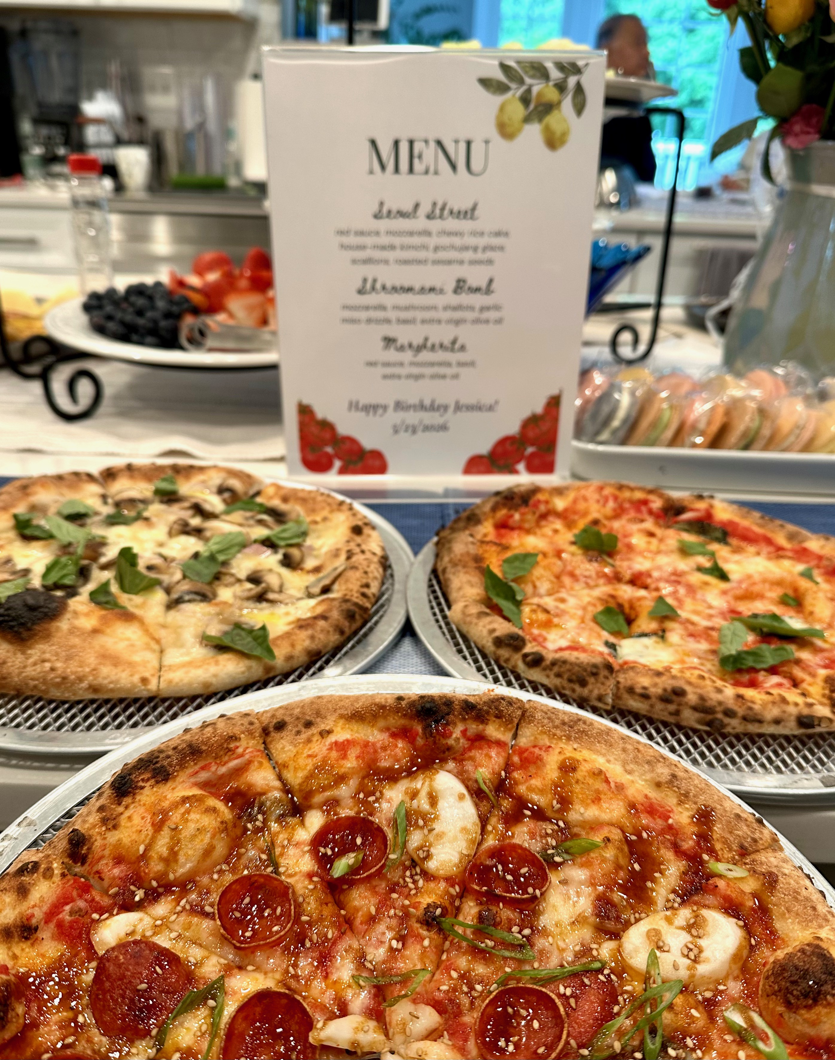 Pizzeria Coco wood-fired pizzas and printed menu at a private party
