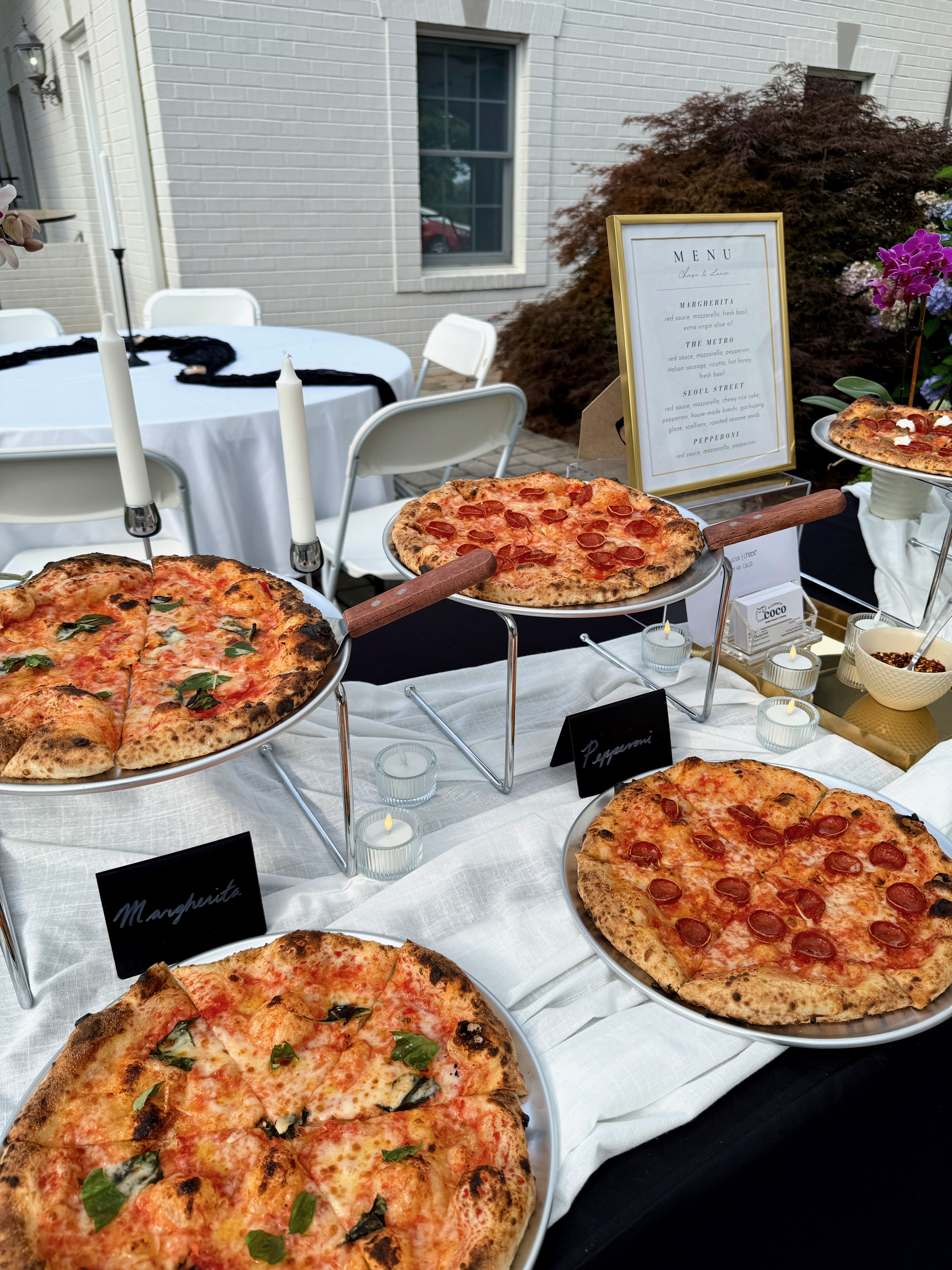 Pizzeria Coco catered pizza spread on an outdoor table at a DMV gathering